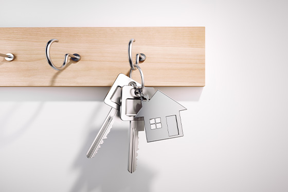keys hanging on a wooden hook with a house-shaped keychain representing home organization and security 3 home keys 3 keychain