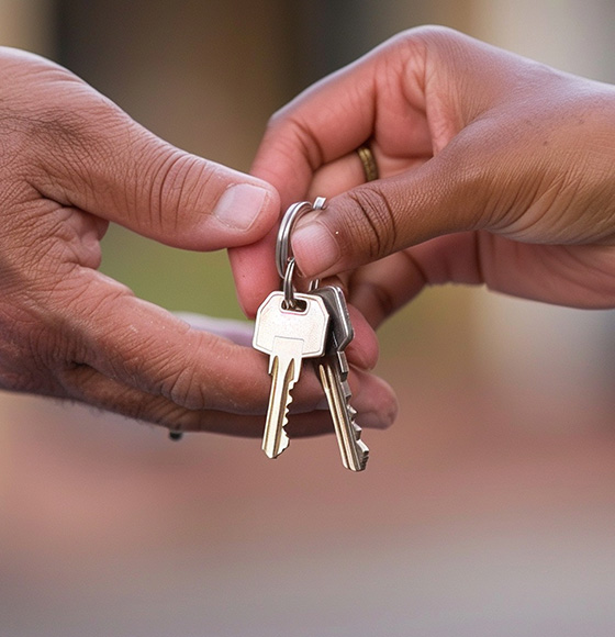 Hands exchanging keys representing a transaction of ownership and responsibility for a new home or apartment two people involved in the process